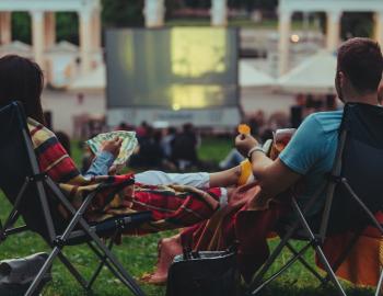 people attending a movie in a park