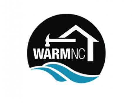 a logo: "Warm NC" in white capital test inside a house graphic and below a hammer graphic. below them, two blue swooshes representing the ocean.