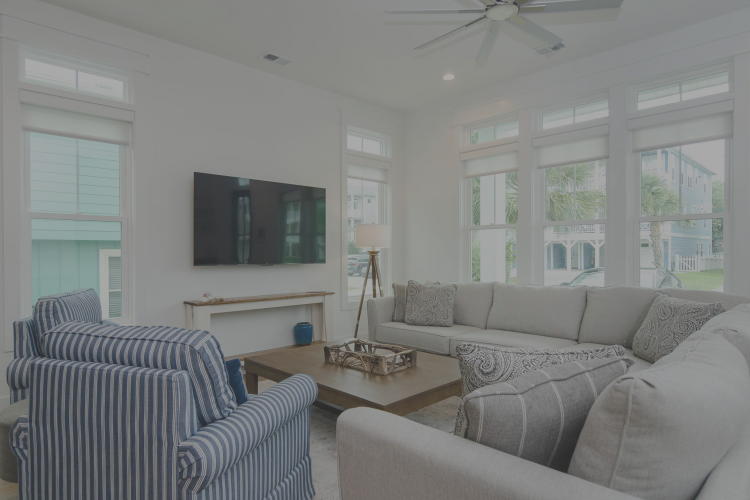 a white living room with a fireplaces and high ceilings