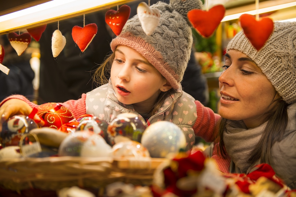 mom and daughter at a christmas market
